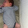 Elio a rejoint le concours — aidez-le/la à gagner de superbes lots ! baby, blanket, child, cushion, cute, face, foot, hand, head, indoor, infant, legs, lying_down, newborn, person, pillow, skin, soft_furniture, striped_onesie, textile