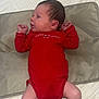 baby, blanket, clothing, cute, fabric, face, foot, hand, head, human, indoors, infant, lying_down, newborn, person, red_onesie, resting, skin, small, soft_texture