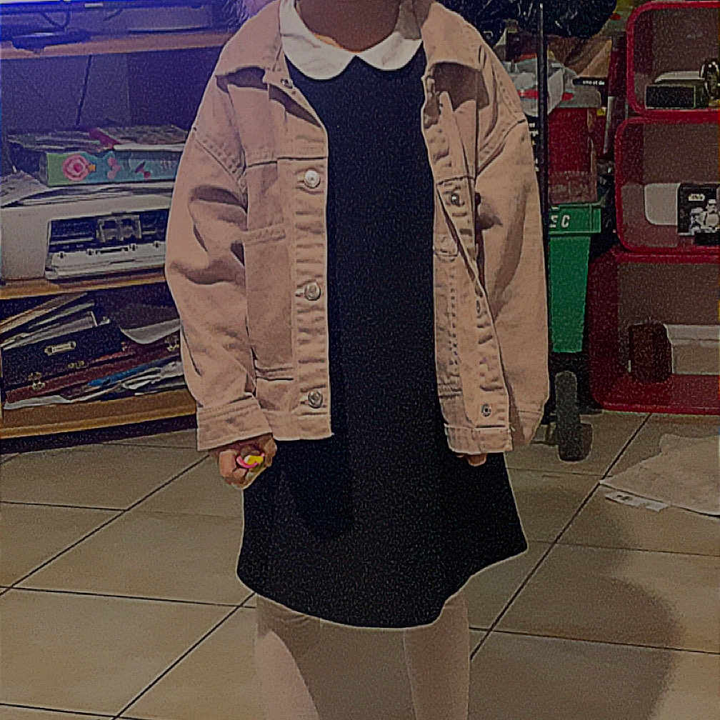 Gabryelle participe au concours pour gagner de l'argent avec cette photo : casual_clothing, child, clutter, dress, floor, furniture, hair, happy, indoor, jacket, person, shelf, smiling, sneakers, standing, television, tights, tiled_floor, toy, young