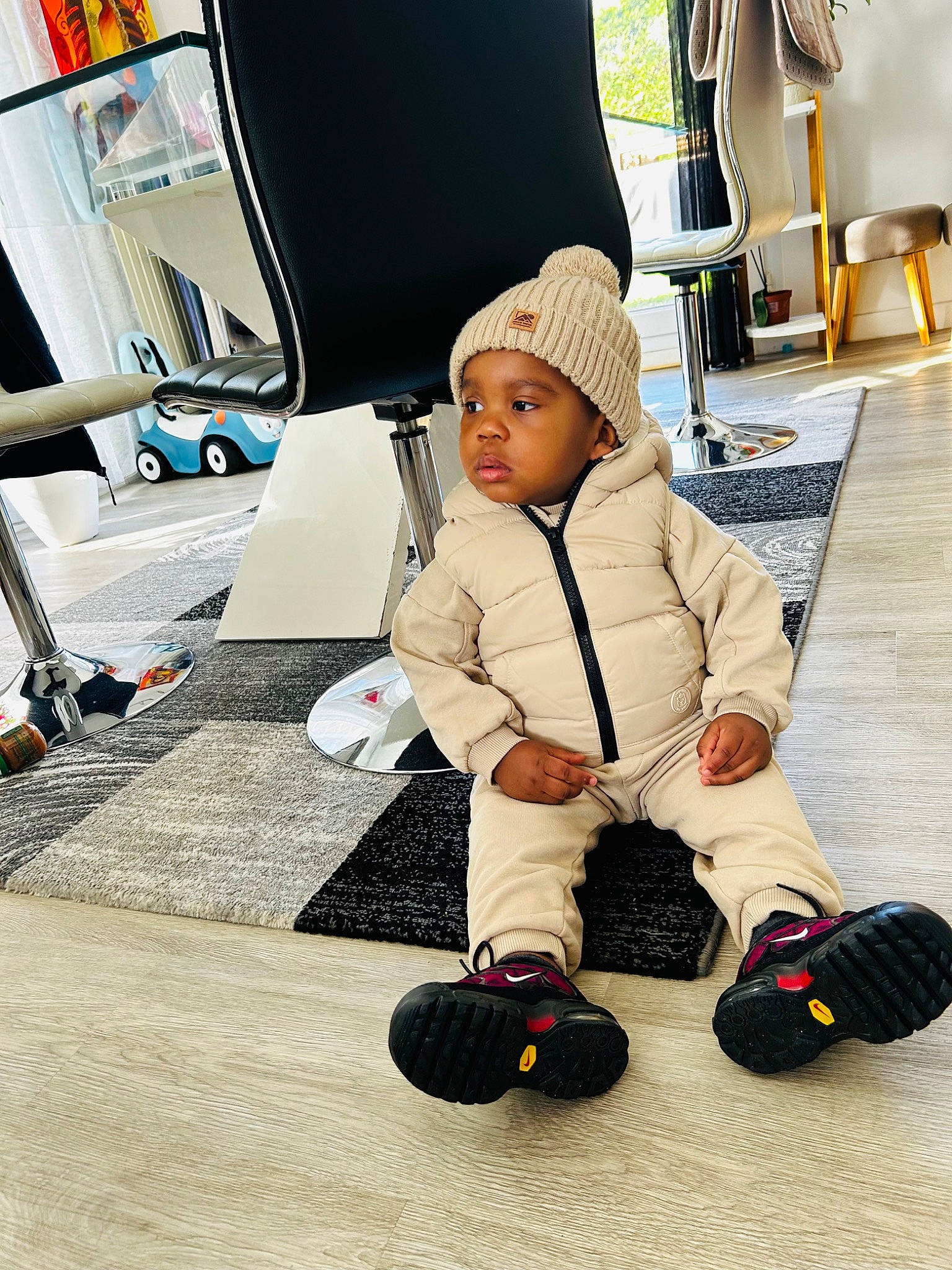 Kenaï participe au concours pour gagner de l'argent avec cette photo : baby, ball, child, comfort, floor, flooring, fun, hat, headwear, hoodie, human_leg, knee, leisure, person, personal_protective_equipment, play, rolling, room, sitting, sports_equipment
