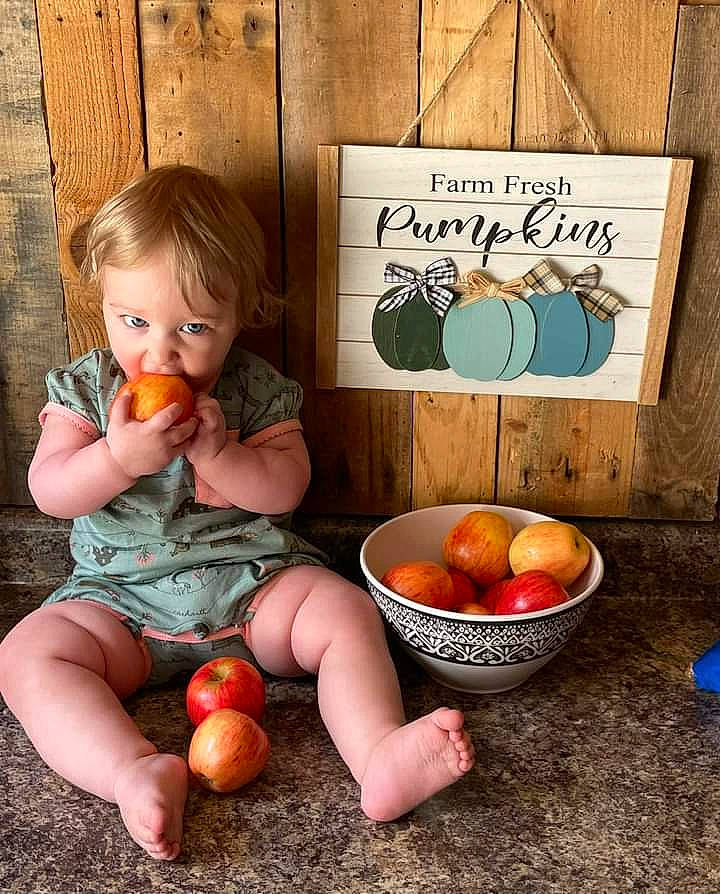 Brooklynn is registered to the contest to win money with this photo: bush_tomato, child, clementine, food, food_group, fruit, grapefruit, ingredient, local_food, natural_foods, orange, person, plant, plum_tomato, produce, sitting, tableware, toddler, vegetable, whole_food