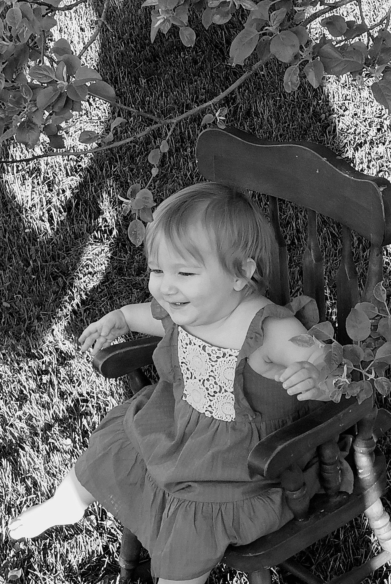 Brooklynn is registered to the contest to win money with this photo: baby_toddler_clothing, black, black_and_white, child, facial_expression, fun, grass, happy, joy, leaf, monochrome, monochrome_photography, pattern, people_in_nature, person, photograph, plant, smile, style, toddler