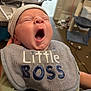 Jaxson joined the competition — help win amazing prizes! baby, yawning, bib, hat, indoor, person, infant, clothing, sleepy, holding, furniture, baby_bassinet, cat_tree, carpet, hand, room, face, cute, child, newborn