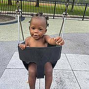 Keeayla joined the competition — help win amazing prizes! barefoot, black_hair, bucket_swing, child, concrete, cute, daytime, fence, grass, happy, outdoor, park, person, play_area, playground, smiling, swing, toddler, trees, young_child