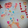 baby, infant, smiling, white_outfit, hat, strawberries, dessert, tart, blanket, food, fruit, cute, happy, lying_down, playful, colorful, sweet, summer, fresh, food_arrangement