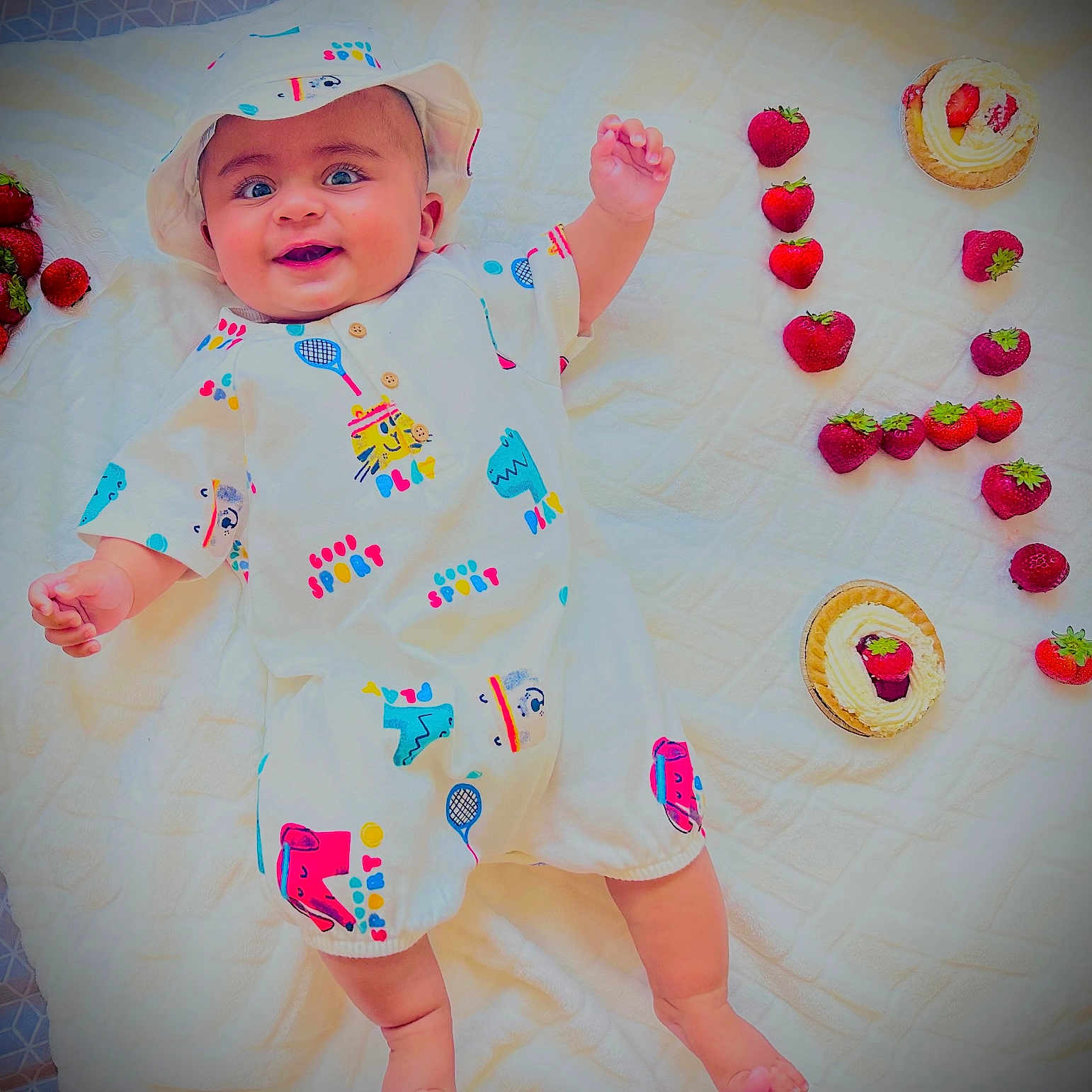 Abdul Hadii joined the competition — help win amazing prizes! baby, blanket, colorful, cute, dessert, food, food_arrangement, fresh, fruit, happy, hat, infant, lying_down, playful, smiling, strawberries, summer, sweet, tart, white_outfit