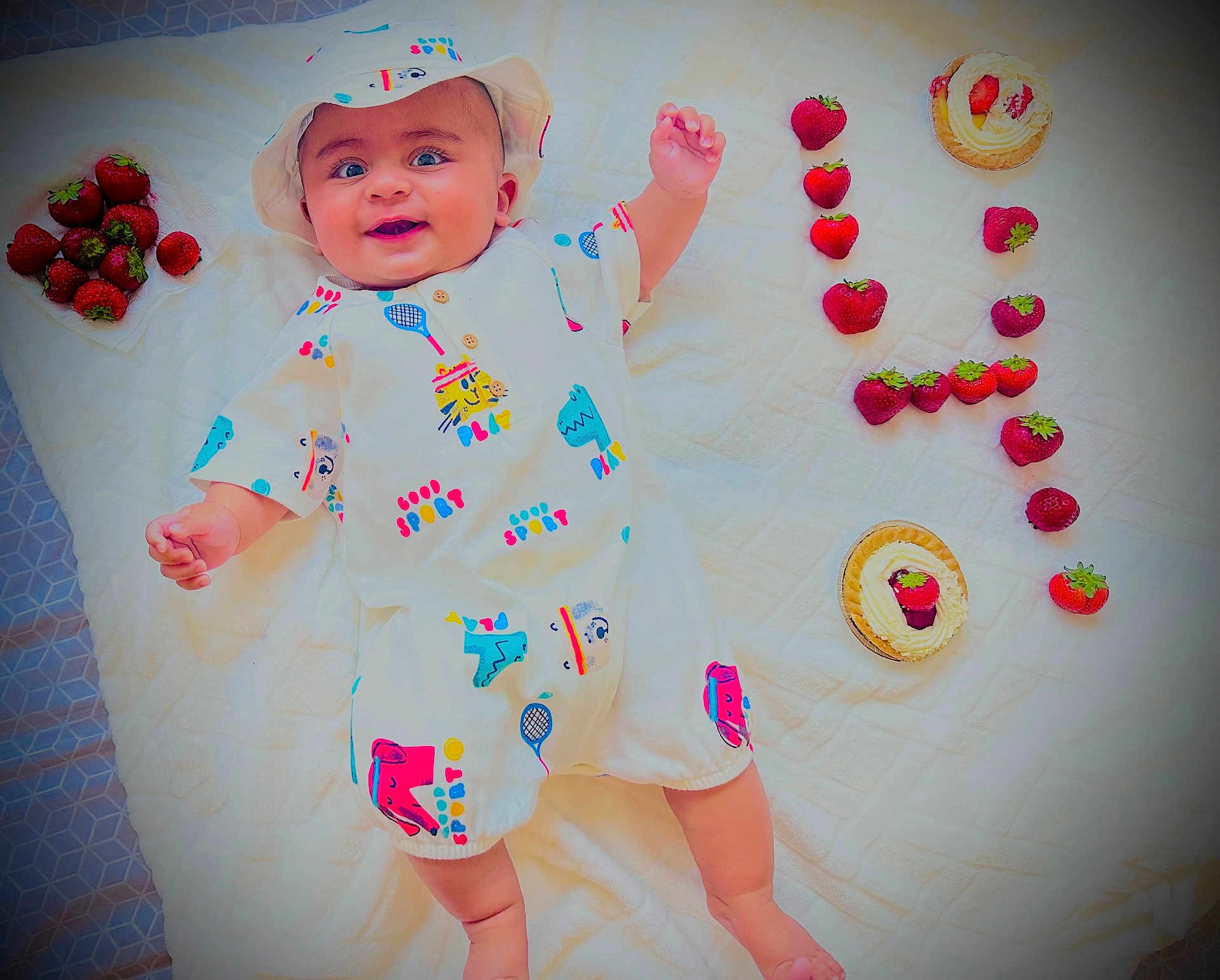 Abdul Hadii joined the competition — help win amazing prizes! baby, infant, smiling, white_outfit, hat, strawberries, dessert, tart, blanket, food, fruit, cute, happy, lying_down, playful, colorful, sweet, summer, fresh, food_arrangement