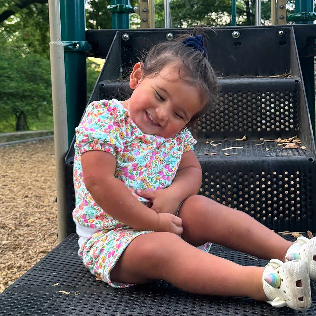 Lucy joined the competition — help win amazing prizes! child, clothing, face, female, footwear, girl, grass, head, nature, outdoorplayarea, outdoors, park, person, photography, plant, playarea, portrait, shoe, sitting, tree