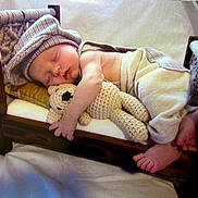 Jaxson joined the competition — help win amazing prizes! baby, sleeping, bed, wooden_bed, crocheted_toy, teddy_bear, hat, pants, infant, peaceful, cozy, cute, small_bed, soft_toy, sleep, child, indoors, resting, tiny_feet, blanket