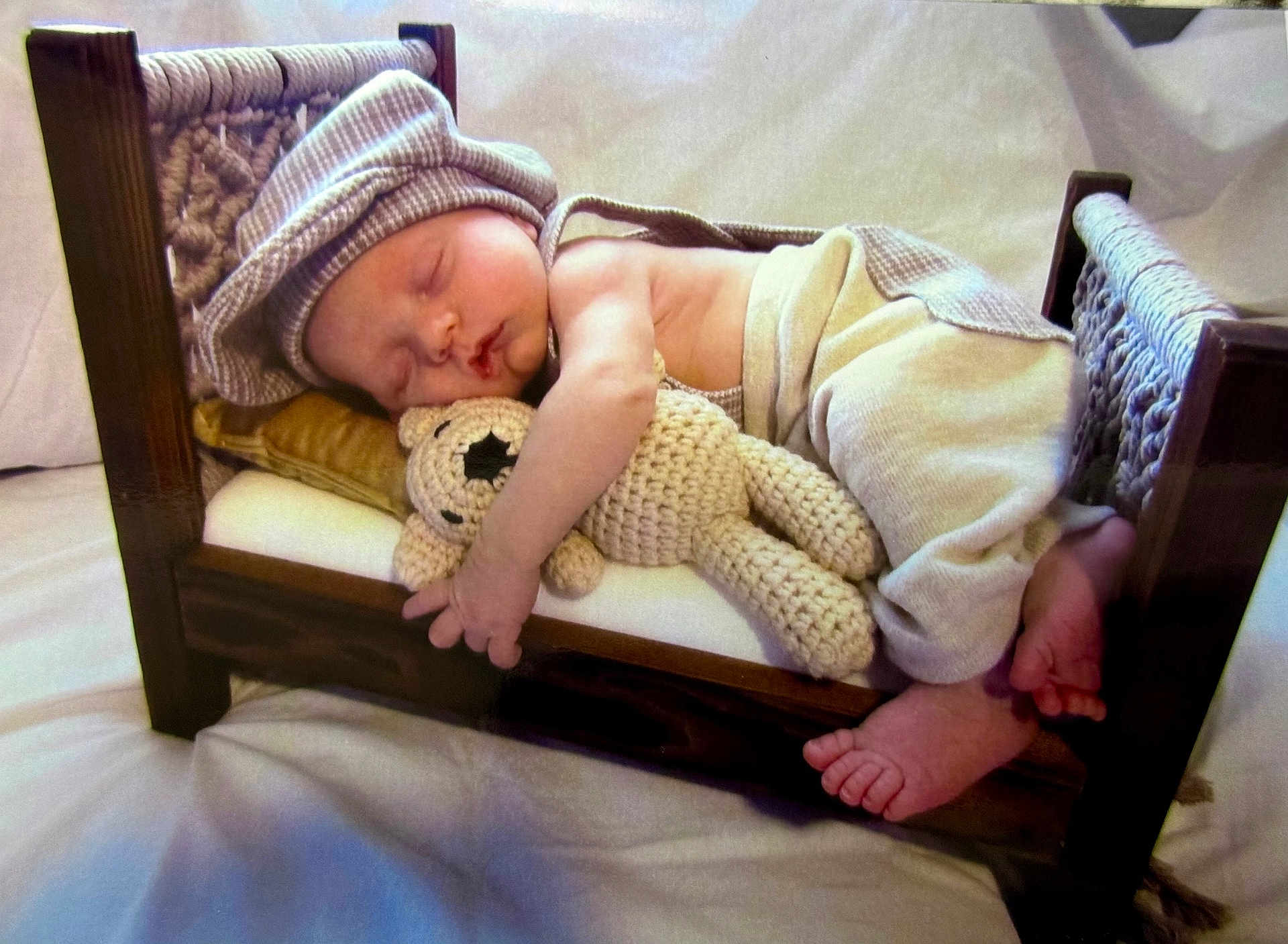 Jaxson joined the competition — help win amazing prizes! baby, sleeping, bed, wooden_bed, crocheted_toy, teddy_bear, hat, pants, infant, peaceful, cozy, cute, small_bed, soft_toy, sleep, child, indoors, resting, tiny_feet, blanket
