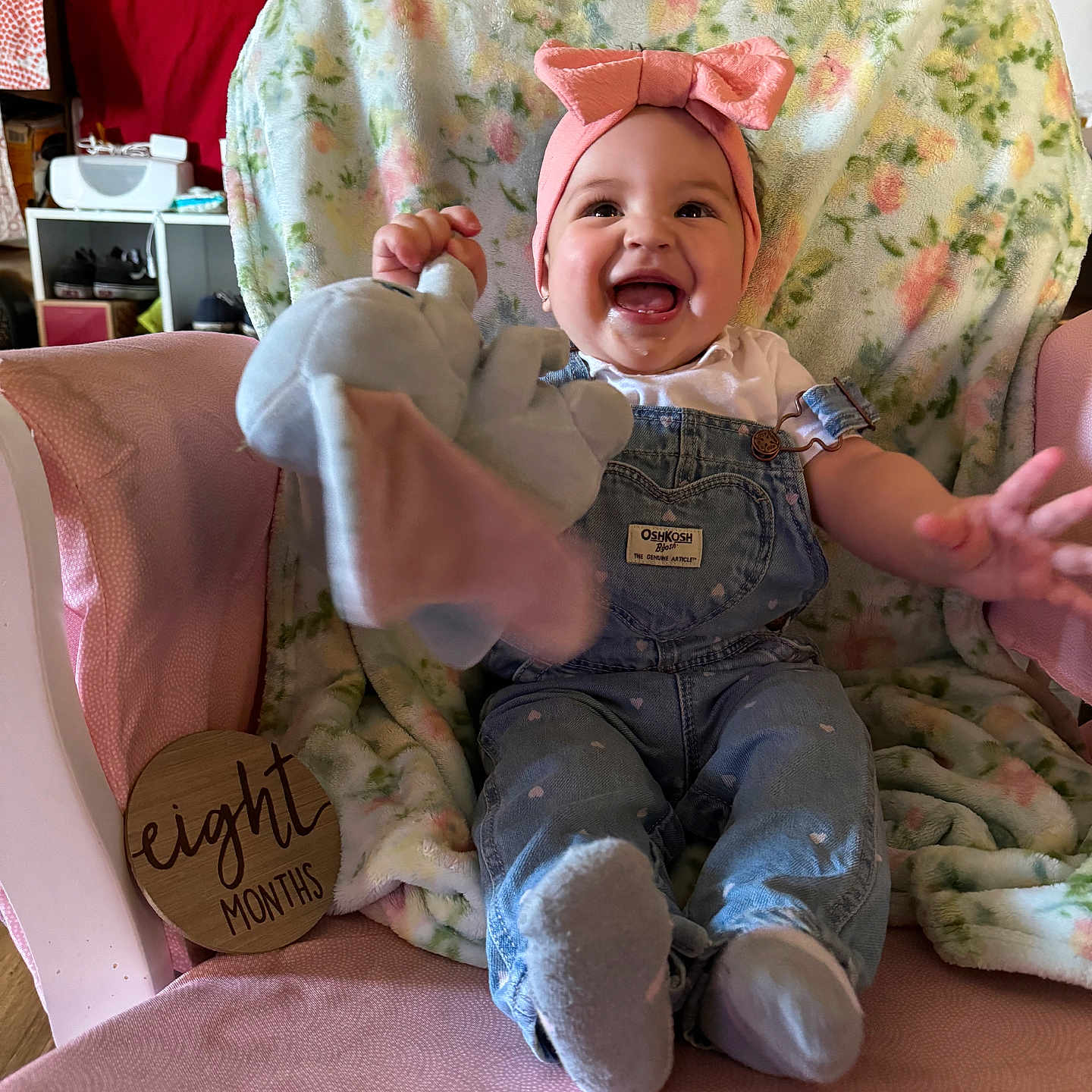 Lillian is registered to the contest to win money with this photo: baby, bodypart, bonnet, chair, clothing, couch, cushion, face, finger, furniture, hand, happy, hat, head, homedecor, pants, person, photography, portrait, toy