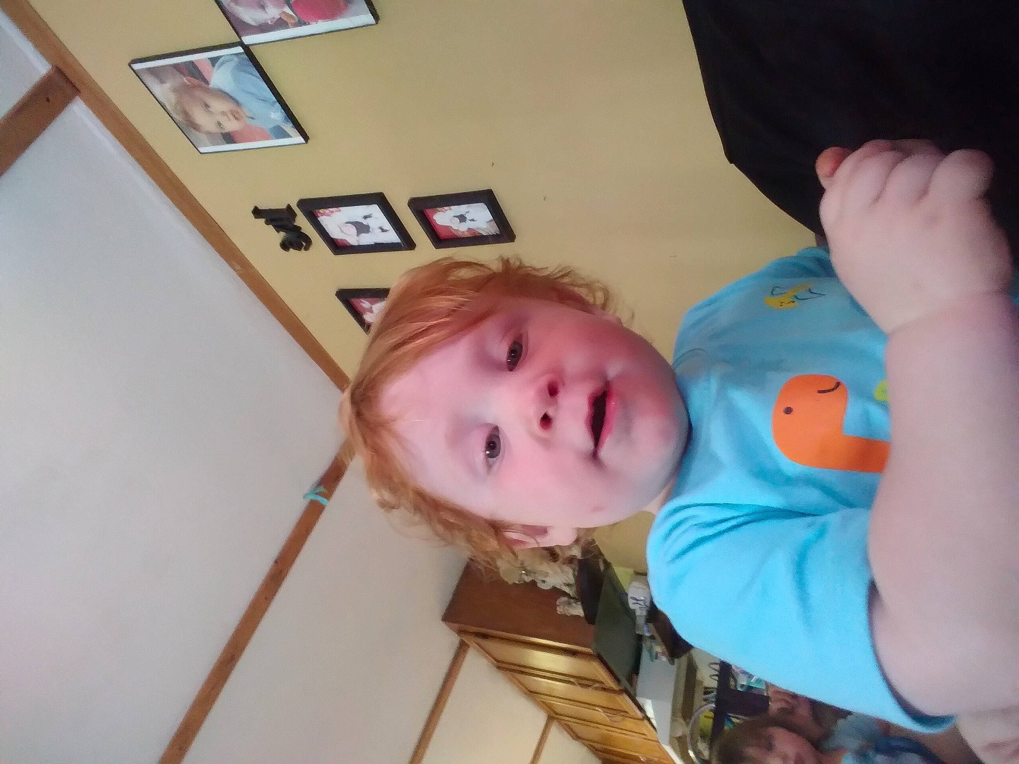 Ernest is registered to the contest to win money with this photo: baby, baby_products, baby_toddler_clothing, cheek, child, chin, flooring, fun, gesture, happy, hardwood, nose, person, picture_frame, play, room, shoulder, sleeve, thumb, toddler