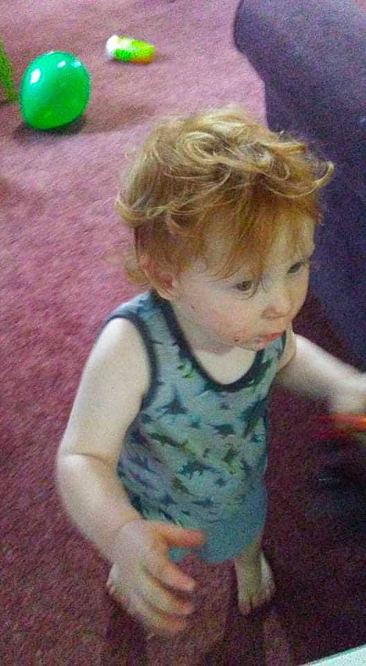 Ernest is registered to the contest to win money with this photo: art, baby, baby_toddler_clothing, balloon, blond, cheek, child, facial_expression, flooring, fun, hair, hand, happy, human_body, pattern, person, play, sitting, sleeve, toddler