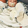 Ilyas participe au concours pour gagner de l'argent avec cette photo : baby, pacifier, blanket, stuffed_animal, sleeping, child, face, cozy, soft_toy, cushion, comfort, indoors, resting, cute, infant, wrapped, head, peaceful, homedecor, person