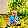 baby, child, outdoor, grass, greenery, plant, yellow_flower, blanket, blue_shirt, pink_shorts, shoes, smiling, happy, sitting, cute, nature, portrait, young_child, sunlight, garden