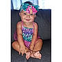 Malena is registered to the contest to win money with this photo: baby, child, smiling, headband, bow, colorful_clothing, mermaid_pattern, sitting, couch, indoors, cute, happy, barefoot, infant, portrait, young_child, playful, toddler, fashion, cozy