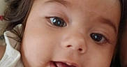 Selena joined the competition — help win amazing prizes! baby, close_up, face, smile, child, infant, eyes, mouth, white_clothing, hair, cute, portrait, indoors, soft_focus, skin, expression, head, young, person, background_blur