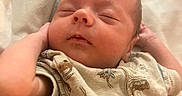 Noah joined the competition — help win amazing prizes! arm, baby, bed, bedding, child, closeup, clothing, cute, face, indoors, infant, newborn, onesie, peaceful, person, portrait, resting, skin, sleeping, soft