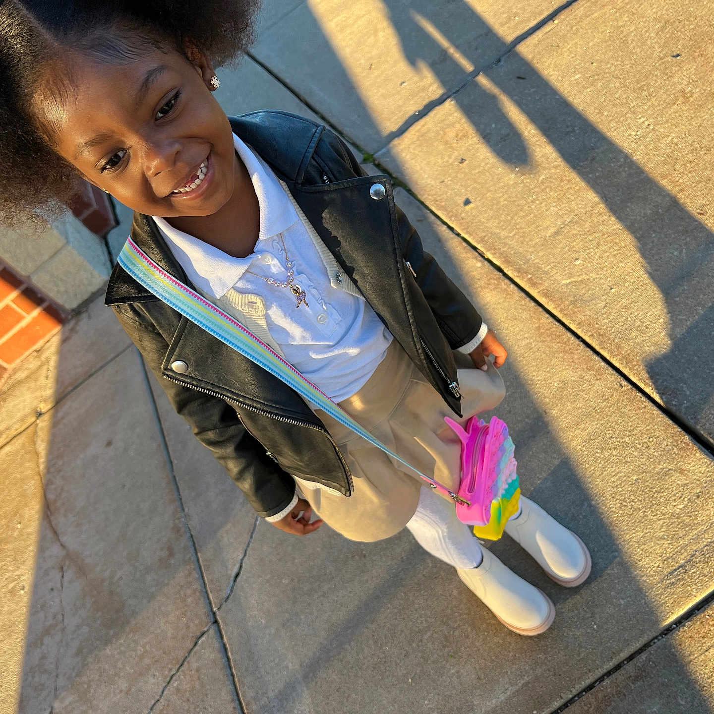 Skylar is registered to the contest to win money with this photo: accessories, blazer, child, city, clothing, coat, face, female, footwear, girl, head, jacket, pants, path, person, photography, portrait, shoe, sidewalk, walking
