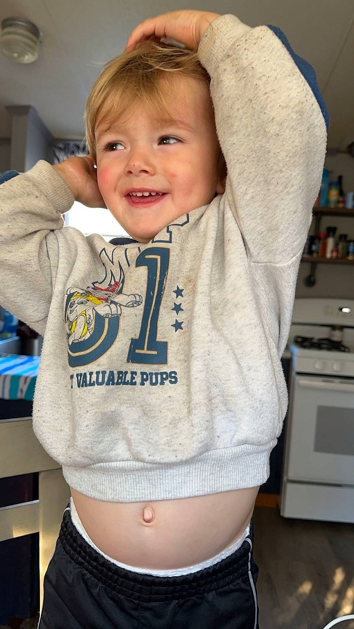 River is registered to the contest to win money with this photo: arm, baby, baby_toddler_clothing, cheek, cool, eye, face, happy, human_body, joy, neck, organ, outerwear, person, skin, sleeve, smile, sportswear, t_shirt, toddler
