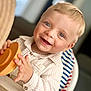 Lucas a rejoint le concours — aidez-le/la à gagner de superbes lots ! toddler, child, smiling, blue_eyes, blond_hair, striped_shirt, high_chair, toy, orange_toy, happy, indoors, portrait, baby, cute, infant, person, face, hand, seated, casual