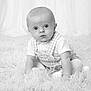 baby, child, infant, portrait, black_and_white, curtains, fluffy_rug, sitting, cute, wide_eyes, overall, knitted_tights, soft_lighting, indoor, young_child, monochrome, studio_photo, curiosity, expression, pose