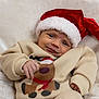 baby, child, christmas, cozy, cute, festive, happy, headwear, holiday, holiday_season, indoors, infant, person, portrait, reindeer, santa_hat, smile, soft_blanket, sweater, warm