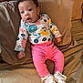 My Ari is registered to the contest to win money with this photo: baby, infant, child, couch, clothing, pink_pants, floral_top, white_shoes, socks, curly_hair, indoor, portrait, cute, small_hands, expression, seated, cozy, soft_furnishing, home, relaxed
