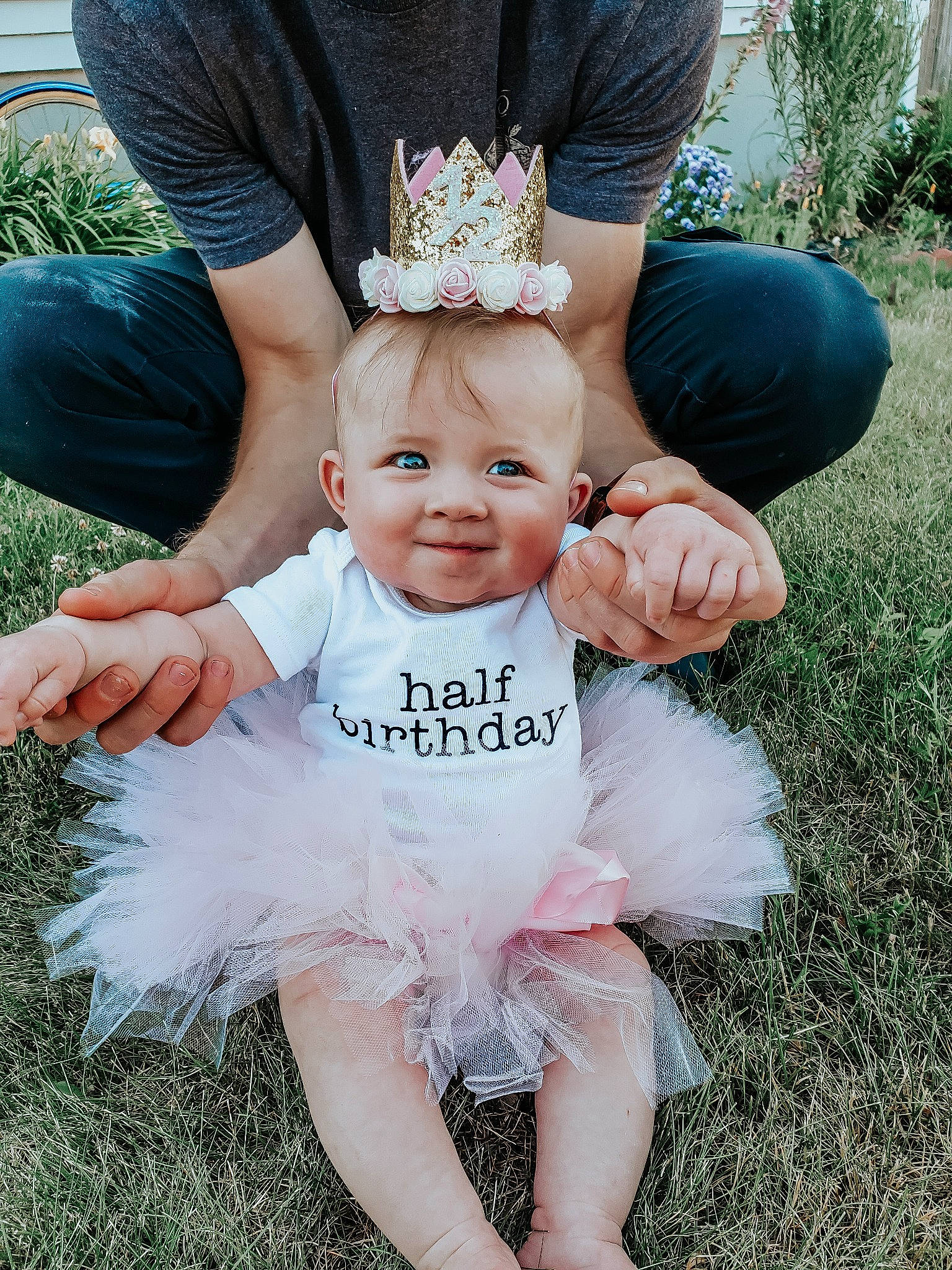 Saoirse is registered to the contest to win money with this photo: baby, baby_toddler_clothing, blue, child, dress, event, fun, gesture, grass, green, happy, headband, headpiece, jewellery, joy, lawn, party_supply, person, pink, plant