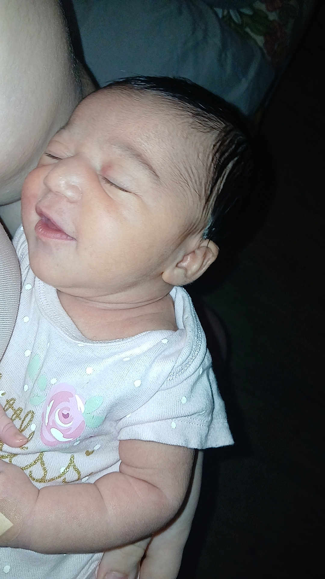 Ava is registered to the contest to win money with this photo: baby, infant, sleeping, person, arm, clothing, onesie, polka_dot, pink, rose, skin, head, face, hand, newborn, cute, closeup, child, holding, resting