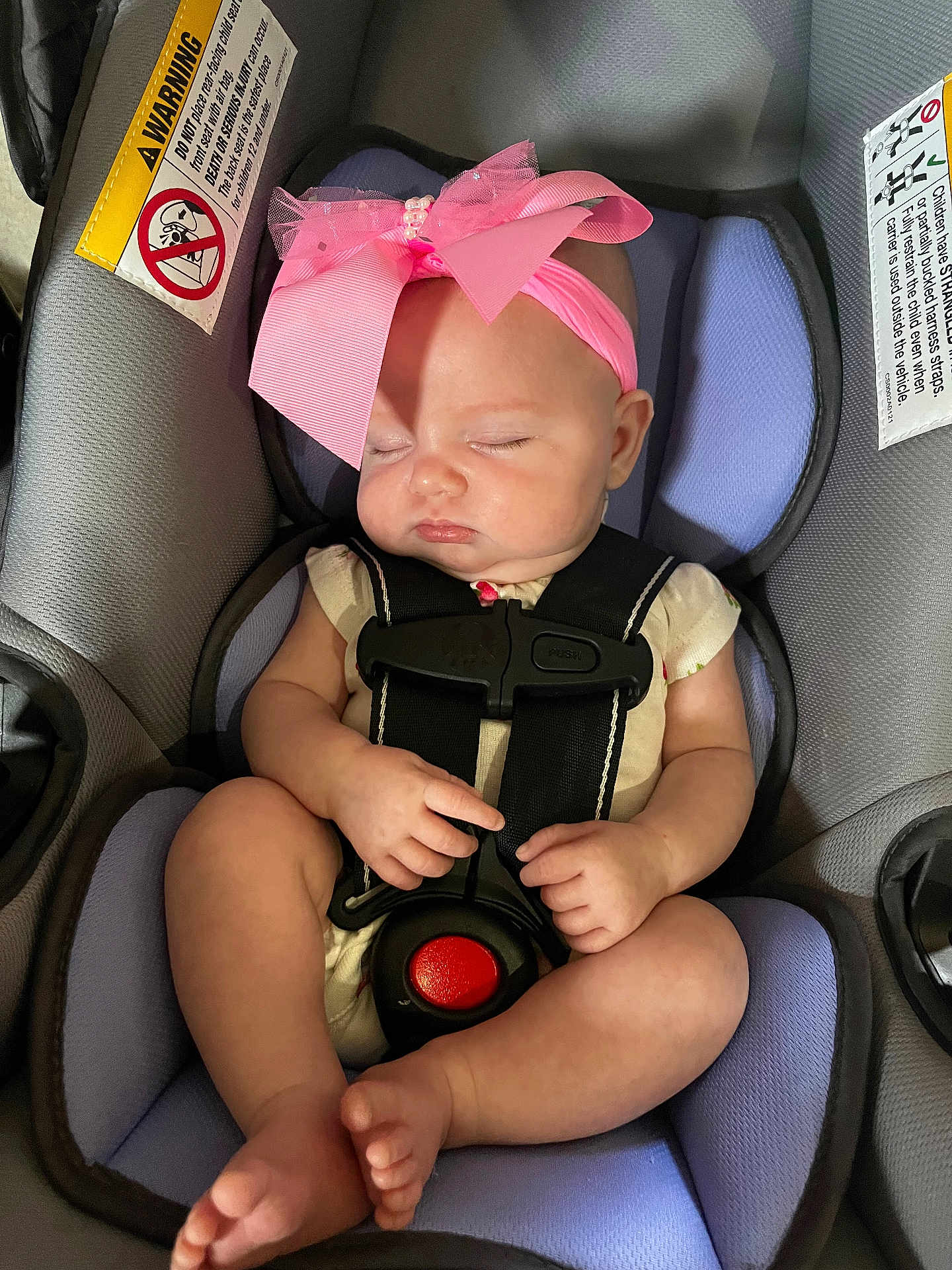 Paris is registered to the contest to win money with this photo: baby, infant, sleeping, car_seat, pink_bow, headband, child, straps, safety, cute, peaceful, skin, legs, hands, footwear_free, indoor, seat, transportation, resting, adorable