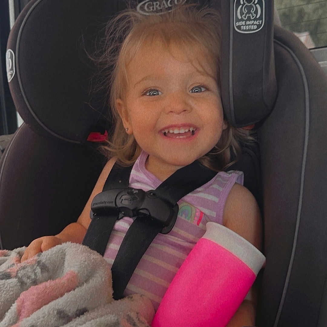 Emersyn is registered to the contest to win money with this photo: accessories, baby, belt, car, car_interior, carseat, clothing, coat, cushion, face, head, homedecor, jacket, lifejacket, person, photography, portrait, transportation, vehicle, vest