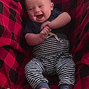 Dallas joined the competition — help win amazing prizes! baby, blanket, cozy, fabric, face, feet, hands, happy, head, indoor, infant, laughing, onesie, pattern, person, plaid_blanket, portrait, smiling, striped_pants, toes