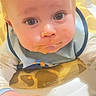 Dallas joined the competition — help win amazing prizes! baby, baby_food, bib, big_eyes, close_up, cute, drool, face, feeding, food, hand, highchair, indoor, infant, looking_at_camera, mealtime, messy_face, portrait, puree, seat