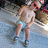 toddler, child, ice_cream, sunglasses, summer, outdoor, steps, casual_clothing, shorts, bare_chest, footwear, sneakers, sunny, messy_face, playful, relaxed, daytime, shaded_area, fun, cute