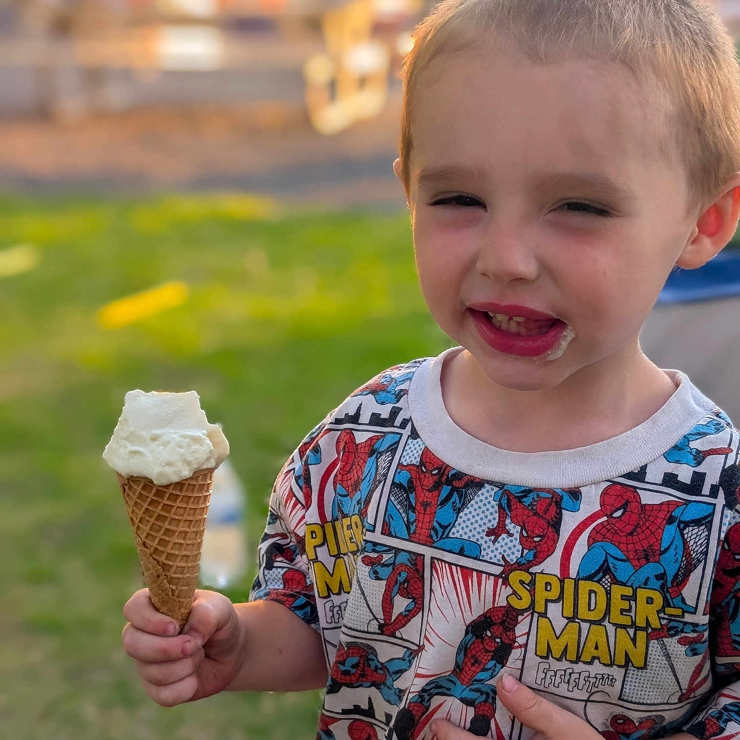 Ariakus joined the competition — help win amazing prizes! child, ice_cream, cone, outdoor, grass, shirt, spiderman, smile, happy, casual, summer, playful, portrait, young, boy, food, sweet, messy, hand, fun