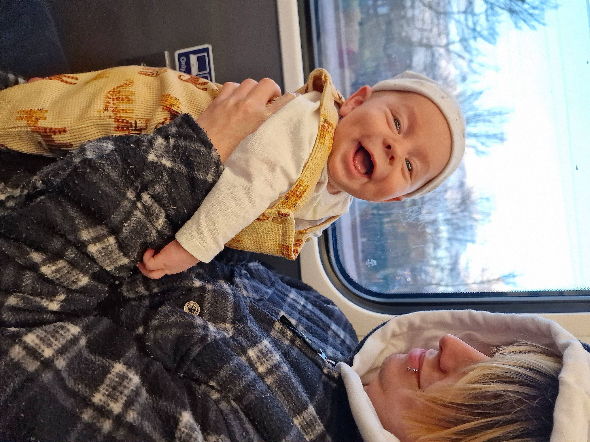 Yuno is registered to the contest to win money with this photo: child, comfort, couch, fun, happy, headwear, lap, leisure, mammal, pattern, person, plaid, room, sitting, smile, tartan, toddler, tree, vacation, vertebrate