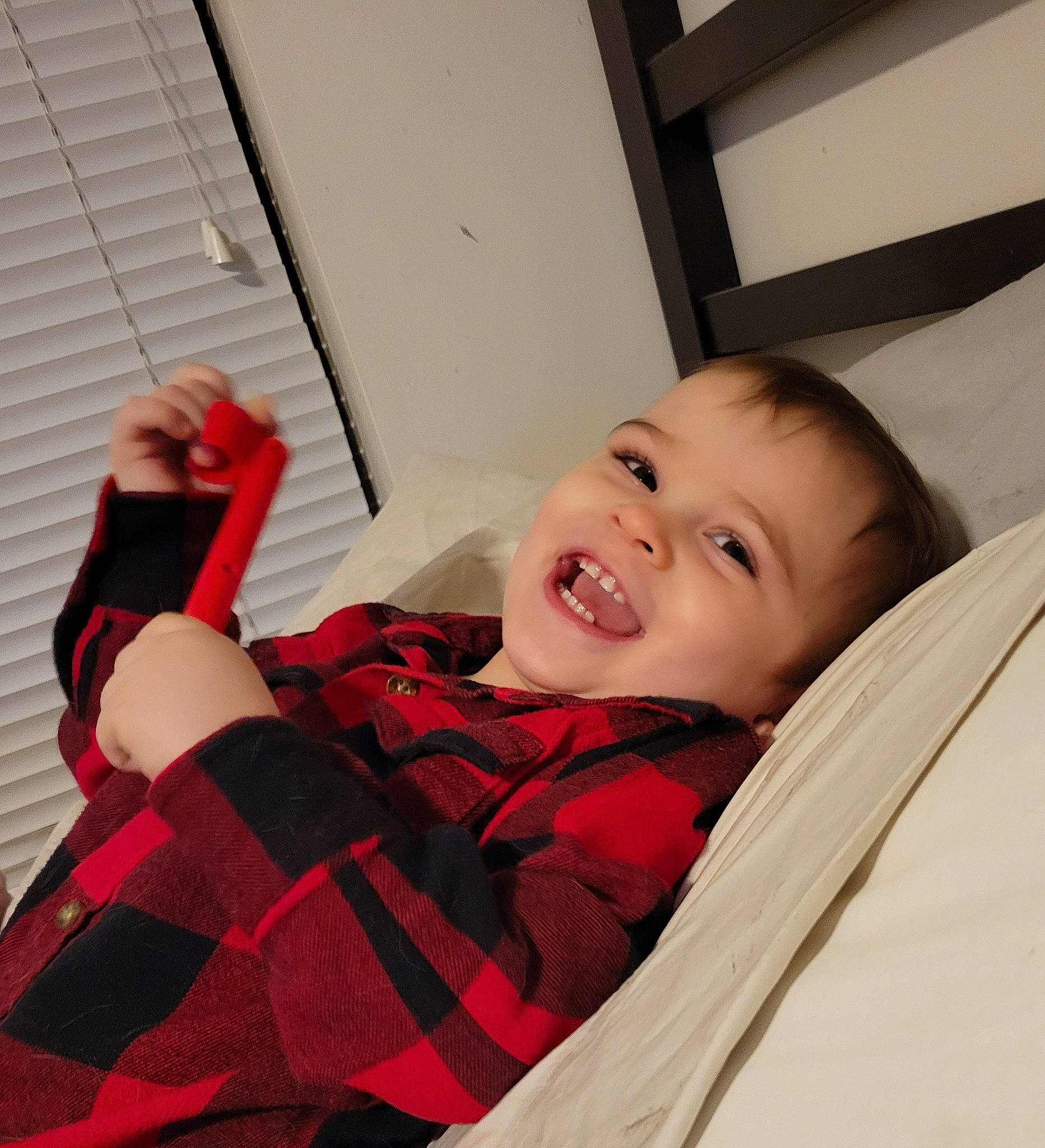 Chandler is registered to the contest to win money with this photo: baby, baby_toddler_clothing, comfort, couch, elbow, finger, fun, gesture, hand, happy, human_body, joy, pattern, person, sitting, sleeve, smile, t_shirt, tartan, toddler