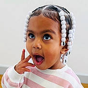 E'Layah joined the competition — help win amazing prizes! toddler, child, braids, beads, surprised, expression, face, portrait, sweater, pink, white, striped, indoor, cute, young_child, person, happy, skin, head, hair