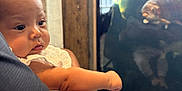 Dianna is registered to the contest to win money with this photo: baby, infant, child, arm, legs, hand, tattoo, aquarium, fish, fish_tank, glass, reflection, curiosity, holding, parent, closeup, portrait, indoor, exhibit, gazing