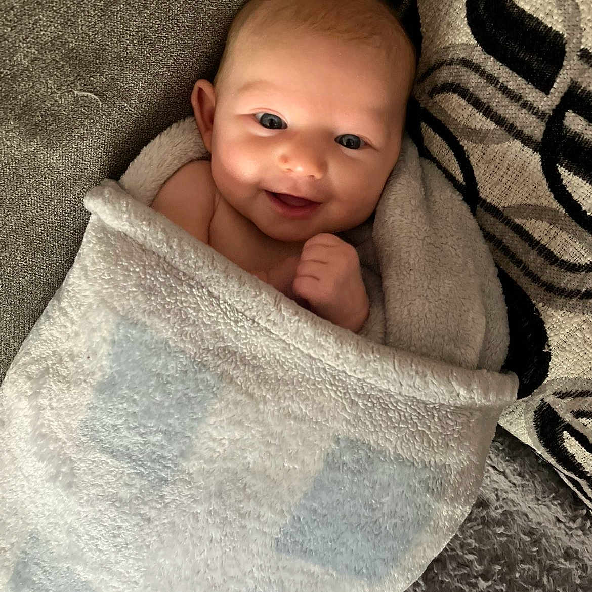 Zara joined the competition — help win amazing prizes! baby, blanket, child, comfort, couch, cozy, cushion, cute, face, happy, indoor, infant, person, portrait, resting, smiling, soft, toddler, wrapped, young