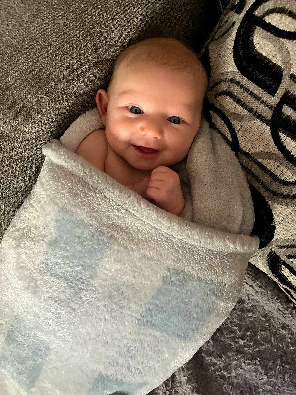 Zara joined the competition — help win amazing prizes! baby, blanket, smiling, face, infant, couch, cushion, cozy, soft, wrapped, child, happy, indoor, portrait, young, cute, comfort, resting, person, toddler