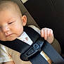 baby, child, car_seat, seatbelt, safety_harness, infant, sleeping, closeup, face, hand, clothing, cute, peaceful, resting, transportation, car_interior, seat, young_child, infancy, soft_light