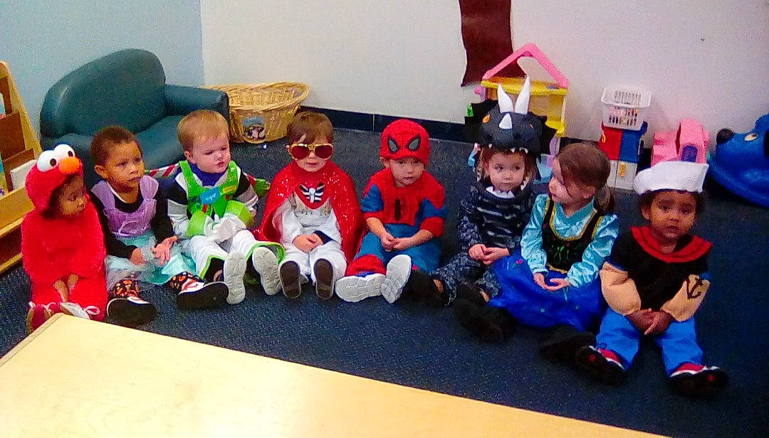 Jamir is registered to the contest to win money with this photo: building, child, community, event, fictional_character, headwear, kindergarten, organization, party, person, play, room, school, team, toddler, toy