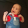 Télio a rejoint le concours — aidez-le/la à gagner de superbes lots ! baby, smiling, red_shirt, denim_overalls, infant, happy, face, hands, clothing, cute, child, portrait, lying_down, playful, young, baby_accessory, pacifier_clip, expression, skin, head