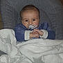 Télio a rejoint le concours — aidez-le/la à gagner de superbes lots ! baby, infant, pacifier, blanket, cushion, chair, clothing, face, hands, indoors, comfort, soft_texture, portrait, child, young, warm, cozy, resting, cute, sleepy