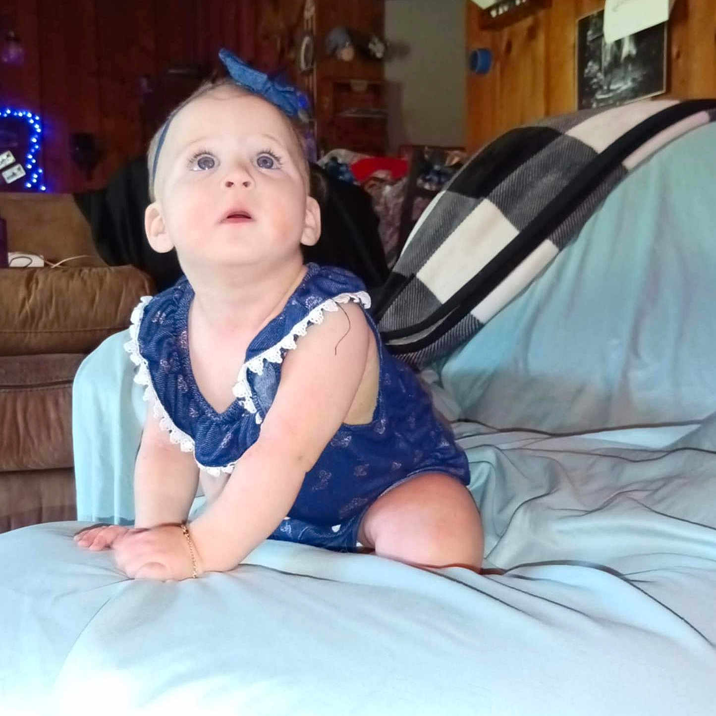 Skyleigh joined the competition — help win amazing prizes! baby, bed, blanket, blue_dress, bracelet, child, couch, crawling, curious, furniture, headband, indoor, infant, light, person, room, sheet, soft, wide_eyes, wood_paneling