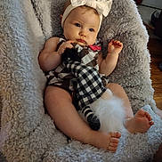 Abby joined the competition — help win amazing prizes! baby, blanket, bow, child, clothing, comfort, cute, floor, foot, gnome, hand, headband, indoor, infant, person, plush_toy, relaxing, seated, soft_texture, wooden_floor