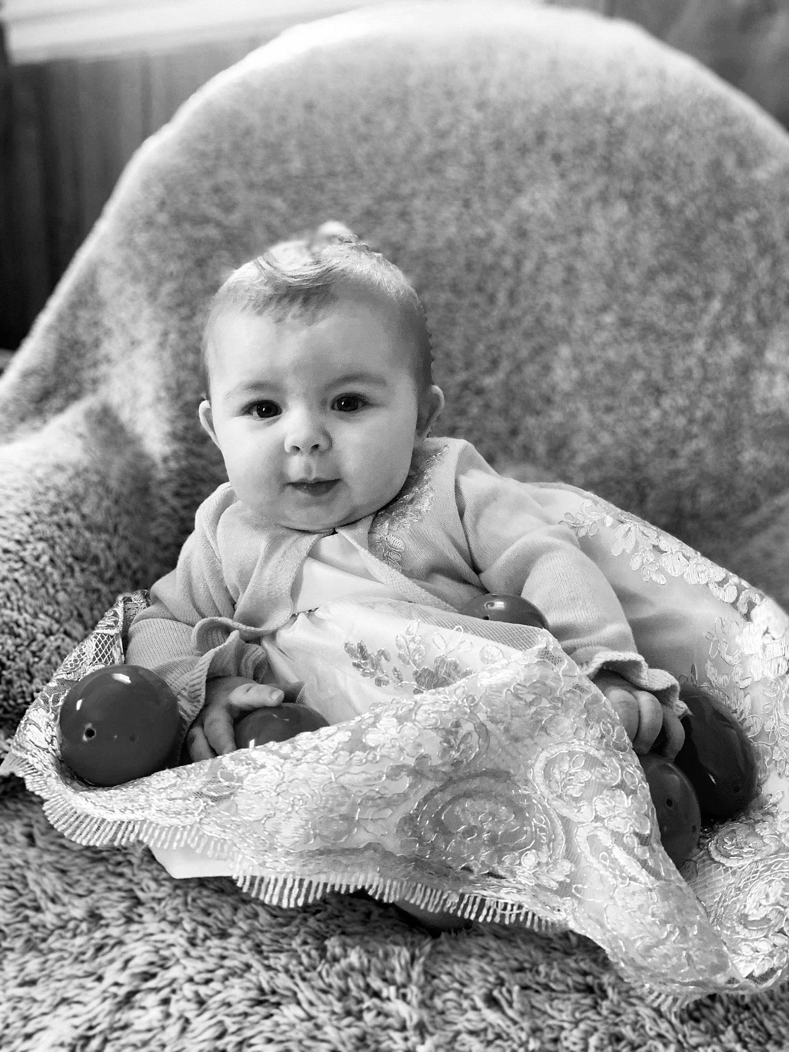 Alexandria is registered to the contest to win money with this photo: baby, baby_toddler_clothing, black_and_white, cheek, comfort, eye, face, flash_photography, grass, grey, happy, head, human_body, iris, monochrome, person, skin, style, toddler, toy