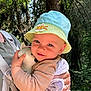baby, child, hat, toy, forest, nature, outdoors, person, hugging, sunlight, trees, greenery, cute, infant, holding, smiling, clothing, adult, daylight, face